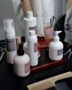 Collection of haircare products including shampoo and conditioner on a salon counter.